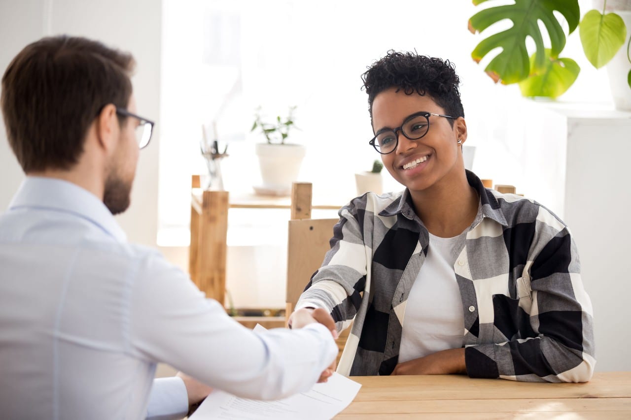 job interview, employer shakes hand of new hire; Recruitment operations concept