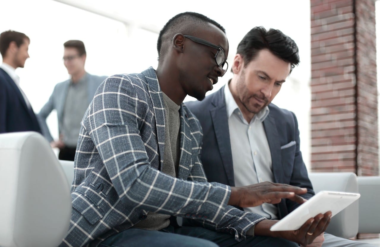 two businesspersons share a tablet; hr transformation concept