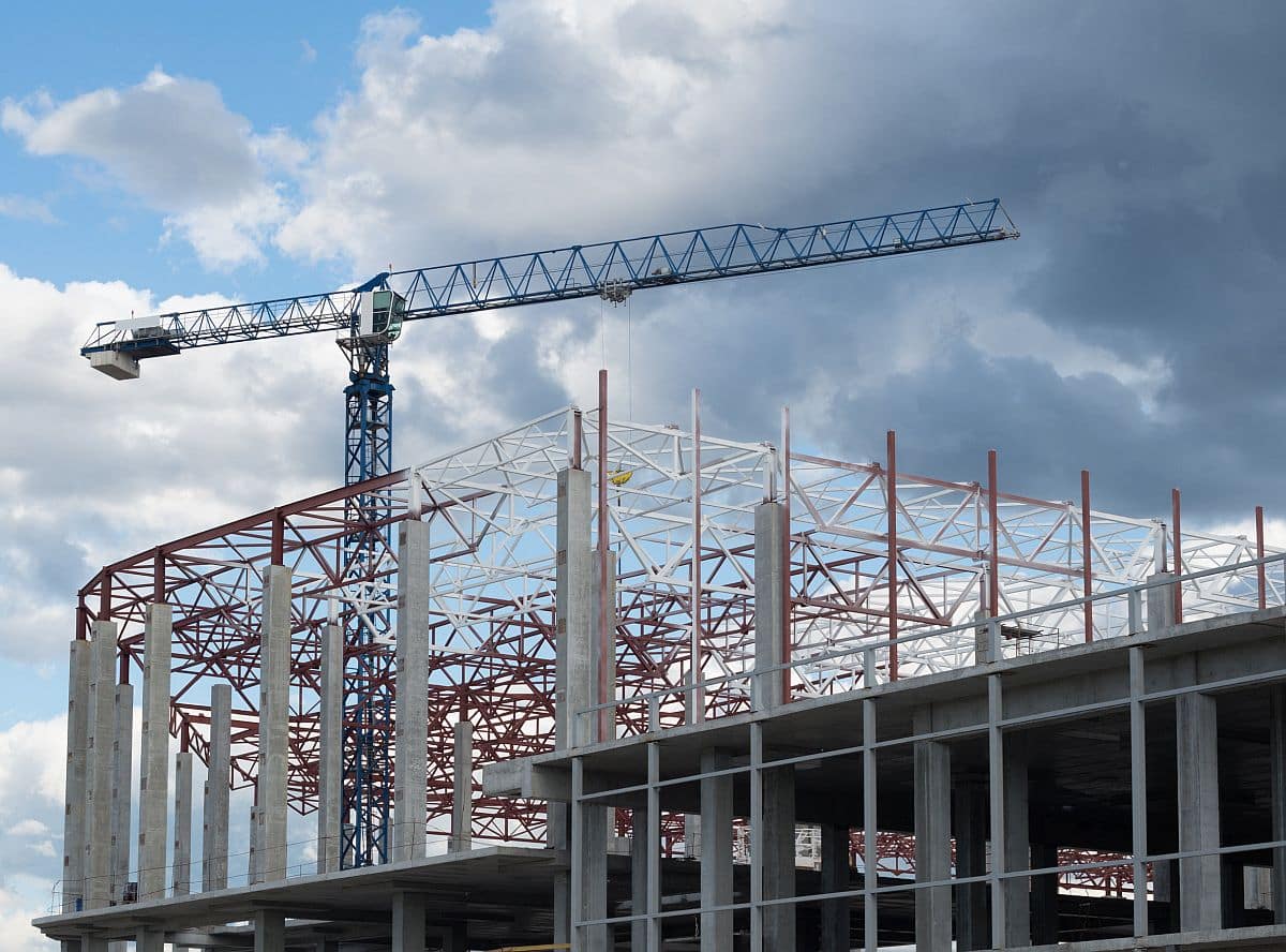 Construction site. Framework of the new building and tower crane above it; global recruiting concept