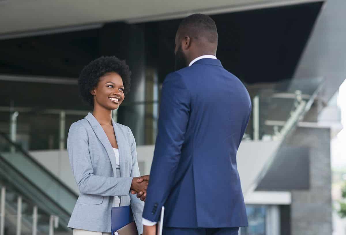 business people shaking hands near office building after job interview; Talent Rediscovery concept