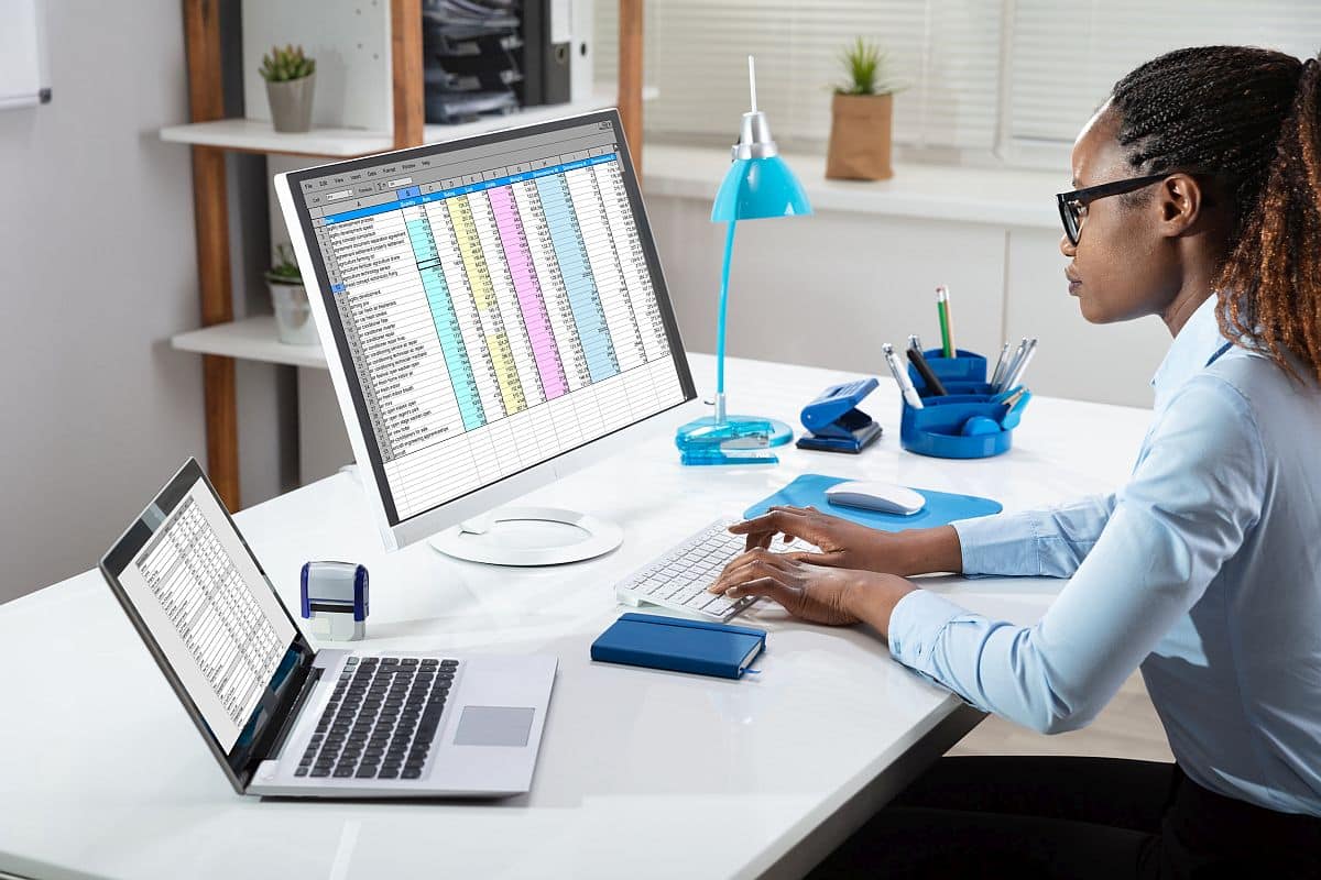 Hand Analyzing Data On Computer Over Desk; AI and better HR decisions concept