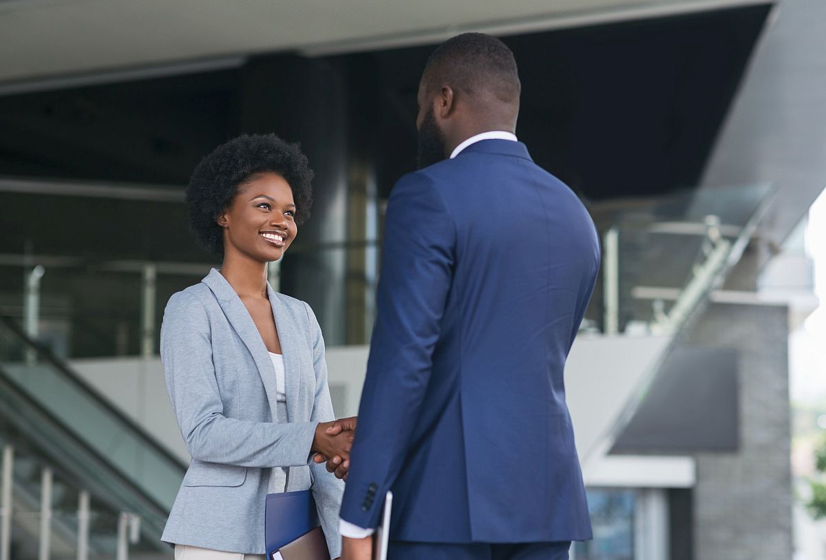 Professional man and woman shaking hands; hire faster concept