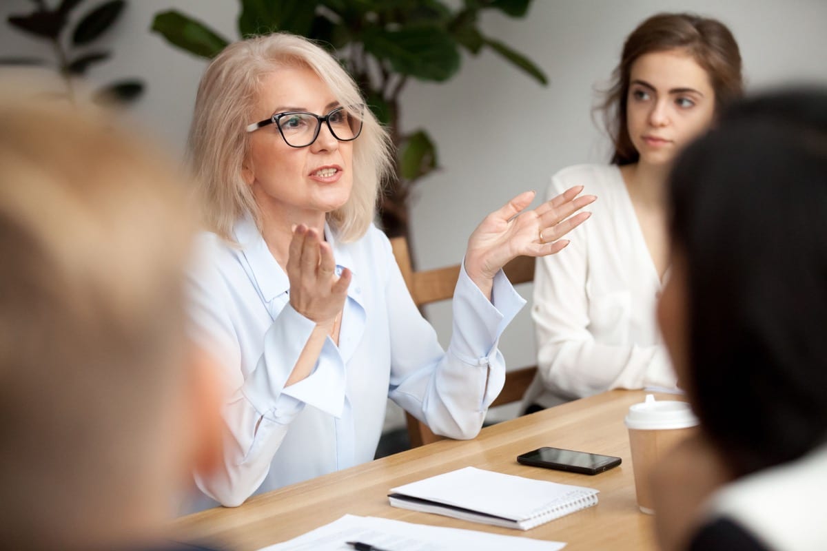 Businesswoman speaking to young people; best workplaces list concept