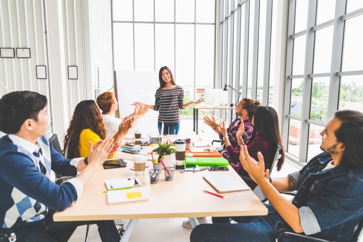 Multiethnic diverse group of creative team or business coworker clapping hands in project presentation; future of hiring concept