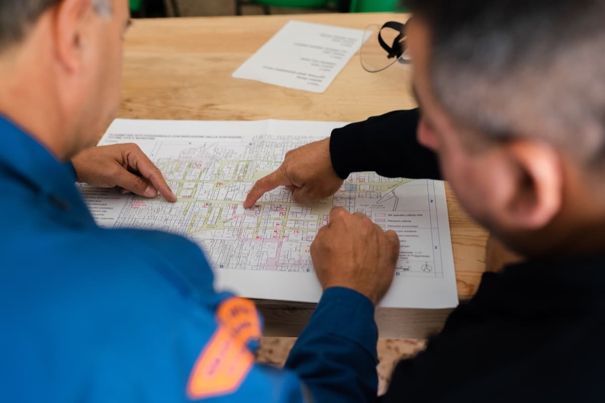 two coworkers review a blueprint; artificial intelligence, automated talent management concept