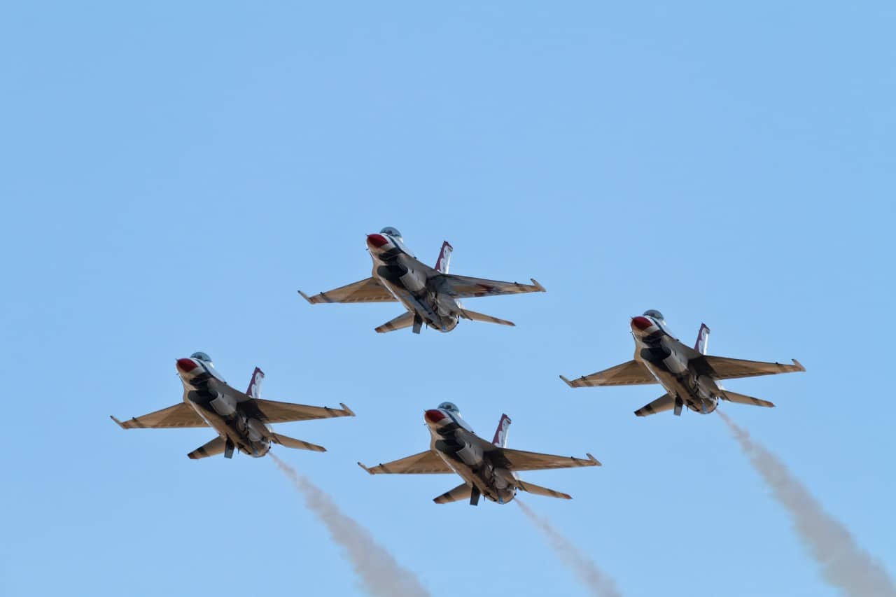 four jets streak across a blue sky; recruit military veterans concept