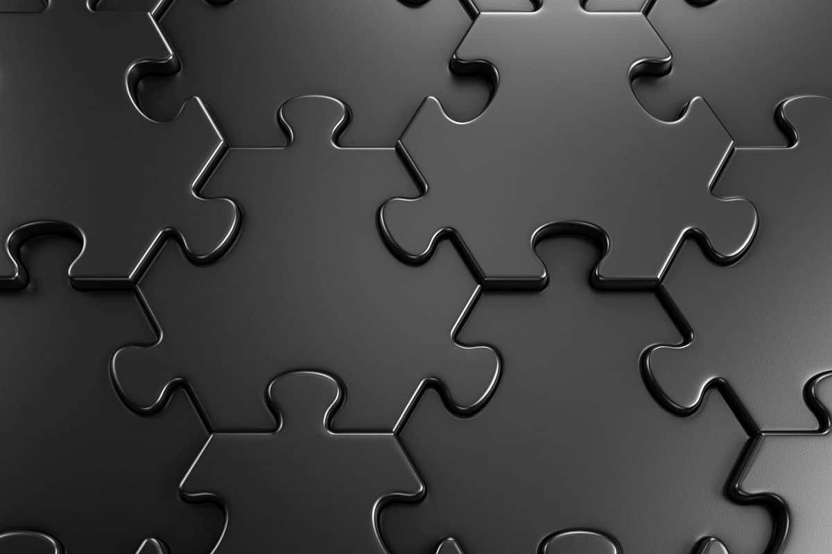 black puzzle pieces fit snuggly together; rebuilding culture in the redefined office concept