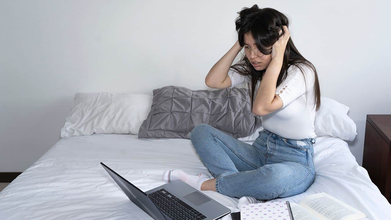 person on laptop at home; unconscious bias and hiring software concept