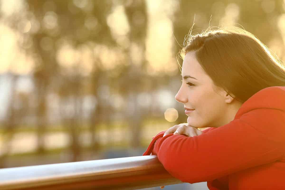 Pensive relaxed girl thinking in winter looking forward at sunset