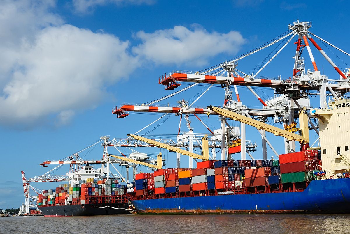 Stacked containers on ship; semiconductor industry concept