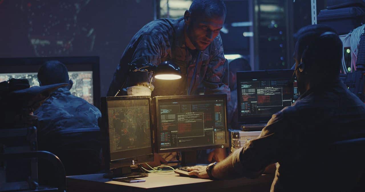 Medium shot of a soldier working on a computer; DOD, AI, military reserves concept