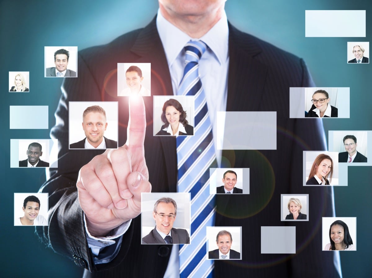 Businessman touching the screen over black background, analytics in hiring concept