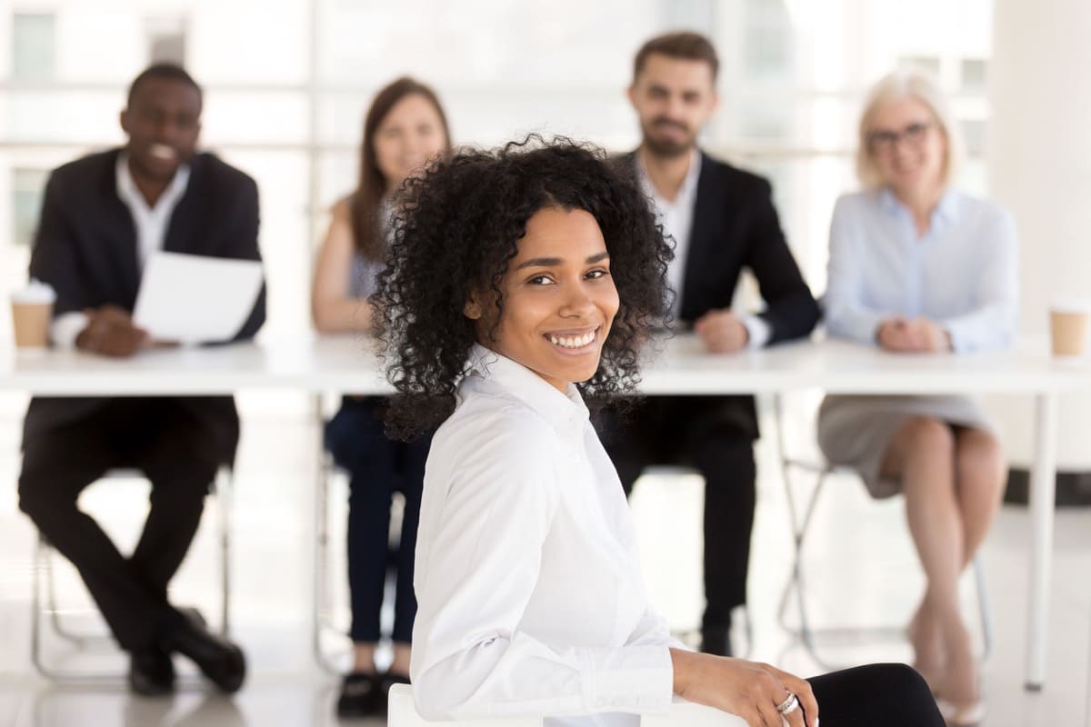 Successful happy mixed race applicant with hr recruiting team portrait, smiling african american woman vacancy candidate or job interview winner looking at camera getting hired, employment concept