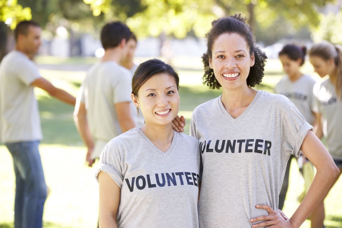 Volunteer Group Clearing Litter In Park; community involvement concept