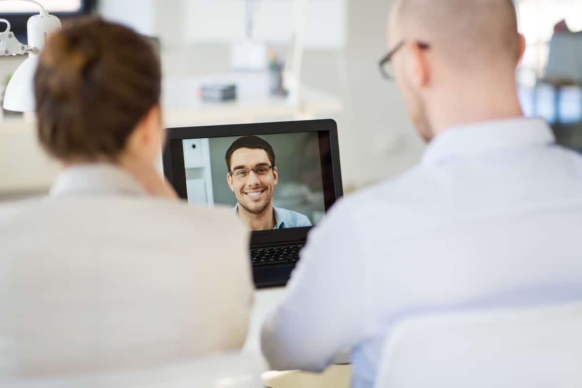 Team of employers holding job interview at office; positive candidate experience concept