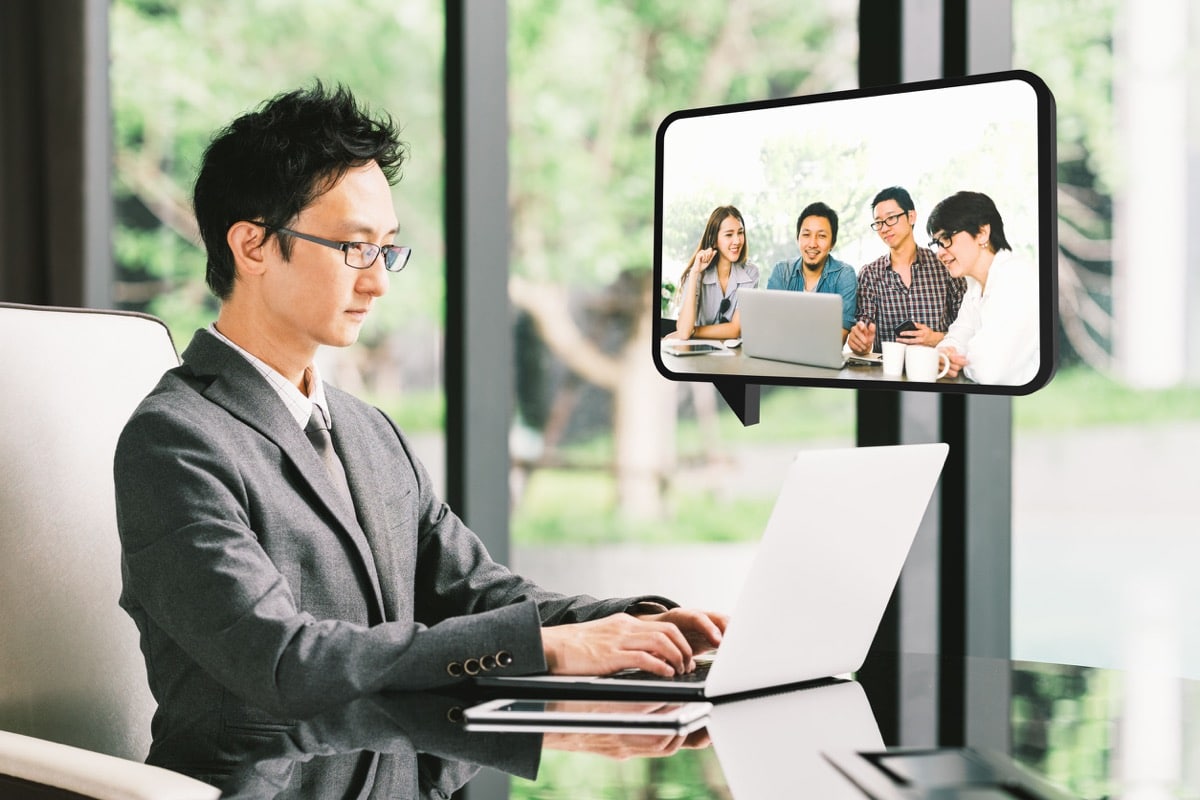 Young Asian businessman, CEO entrepreneur VDO conference call with diverse business partner group or employee. Company leader, remote live online meeting, or financial invest funding advisor concept