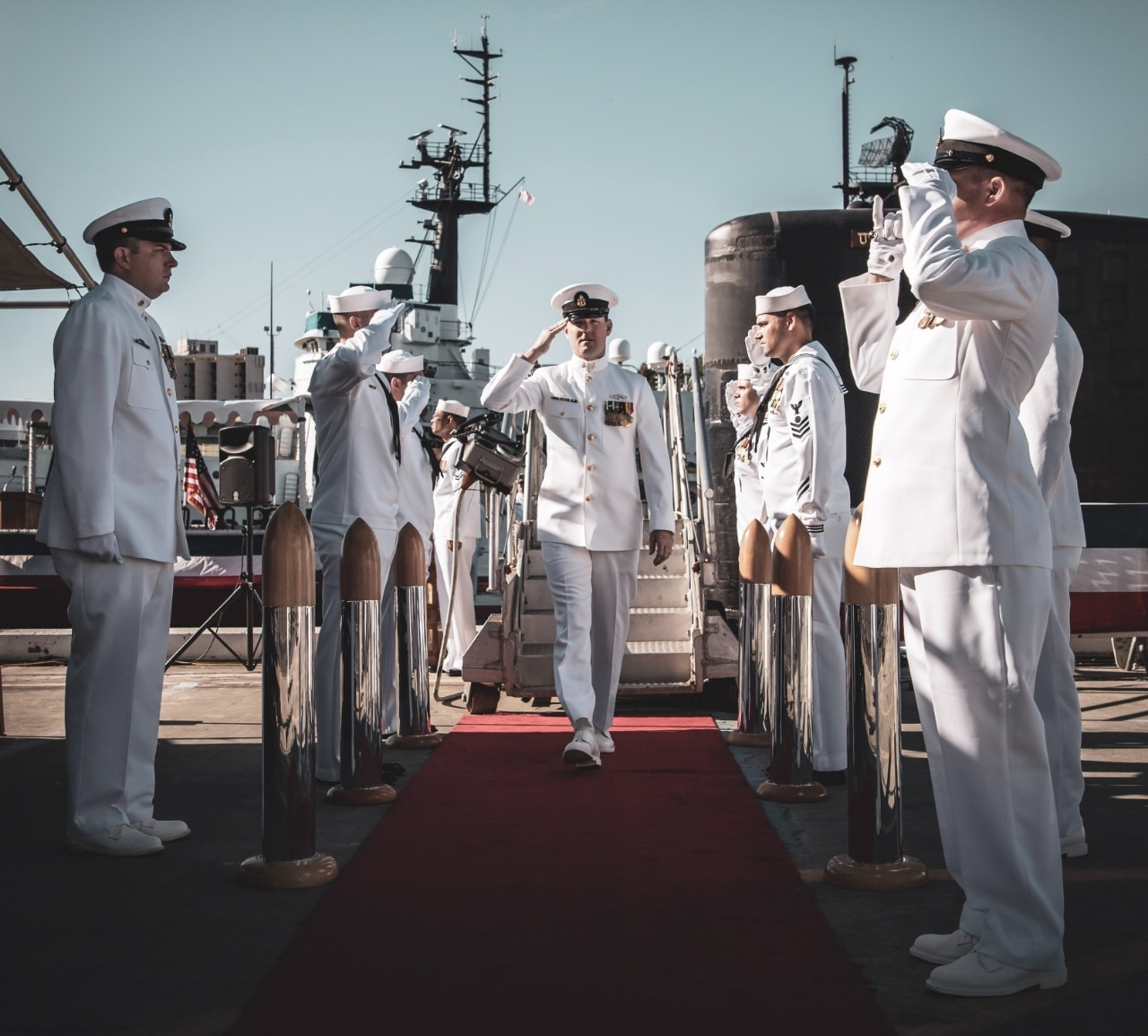 row of naval officers salut their captain; army talent management concept
