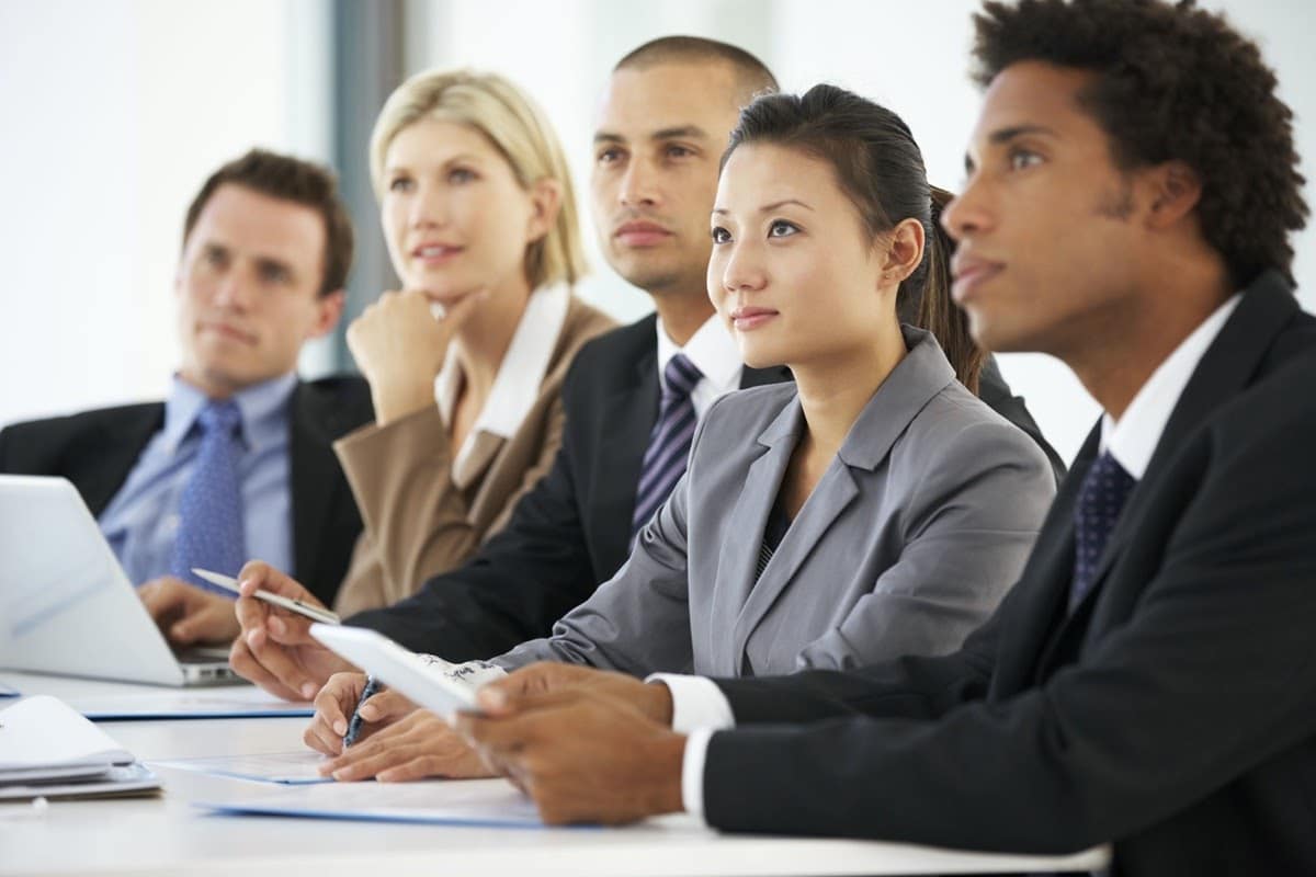 Group Of Business People Listening To Colleague Addressing Office Meeting; ai and employer brand concept