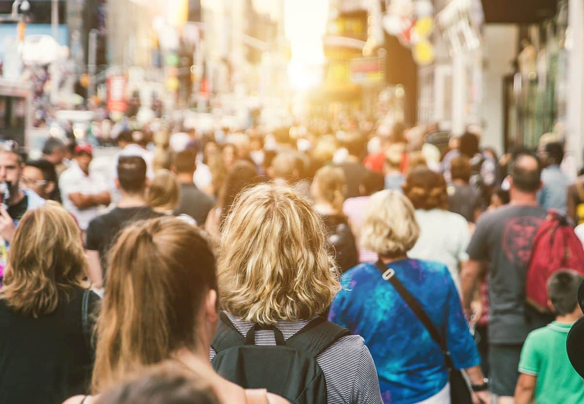 mass of people walking in the city; hire global talent concept