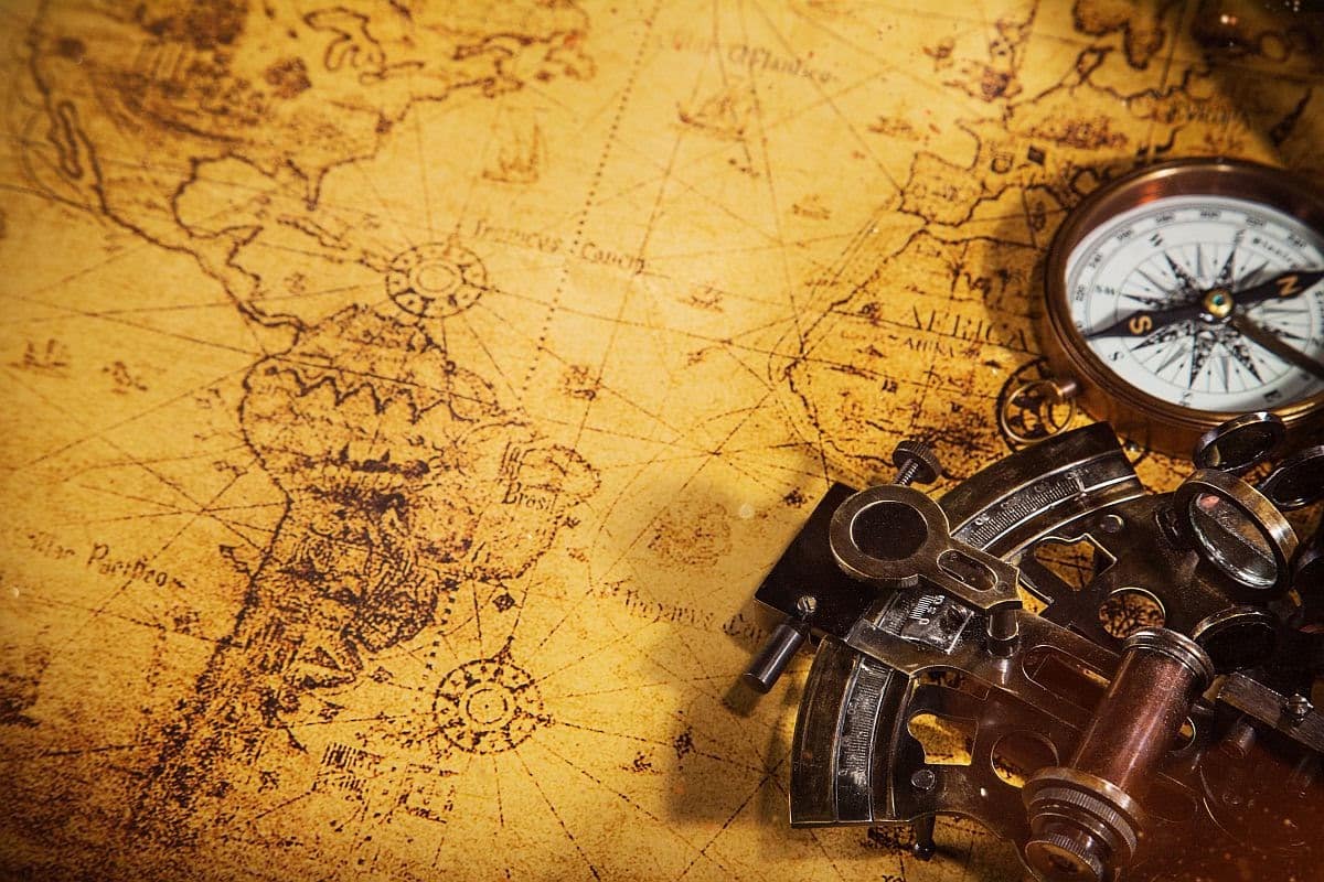 Top view of accessories for travel on vintage wooden background with lots of copy space; talent intelligence for a global workforce concept