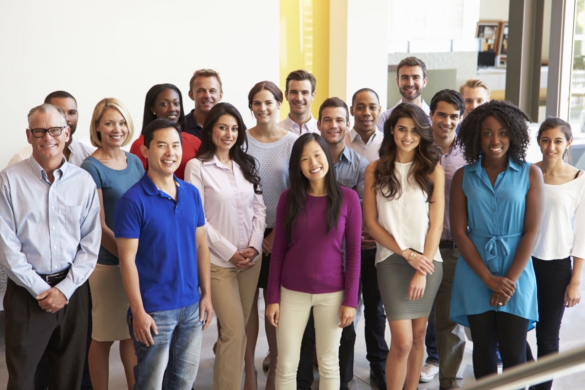 Portrait Of Multi-Cultural Office Staff Standing In Lobby