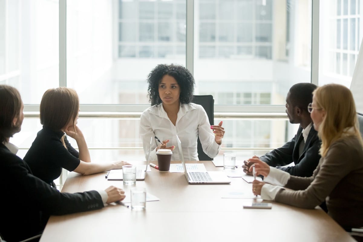 female boss leading corporate meeting; succession planning concept