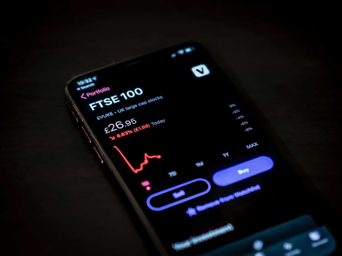 smartphone displaying stock ticker; Hiring During Recession concept