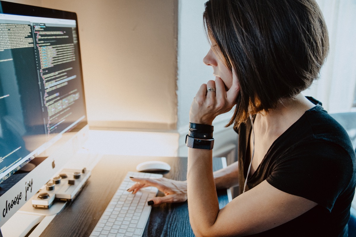 software developer working on code from home office; pandemic impact, dev jobs concept