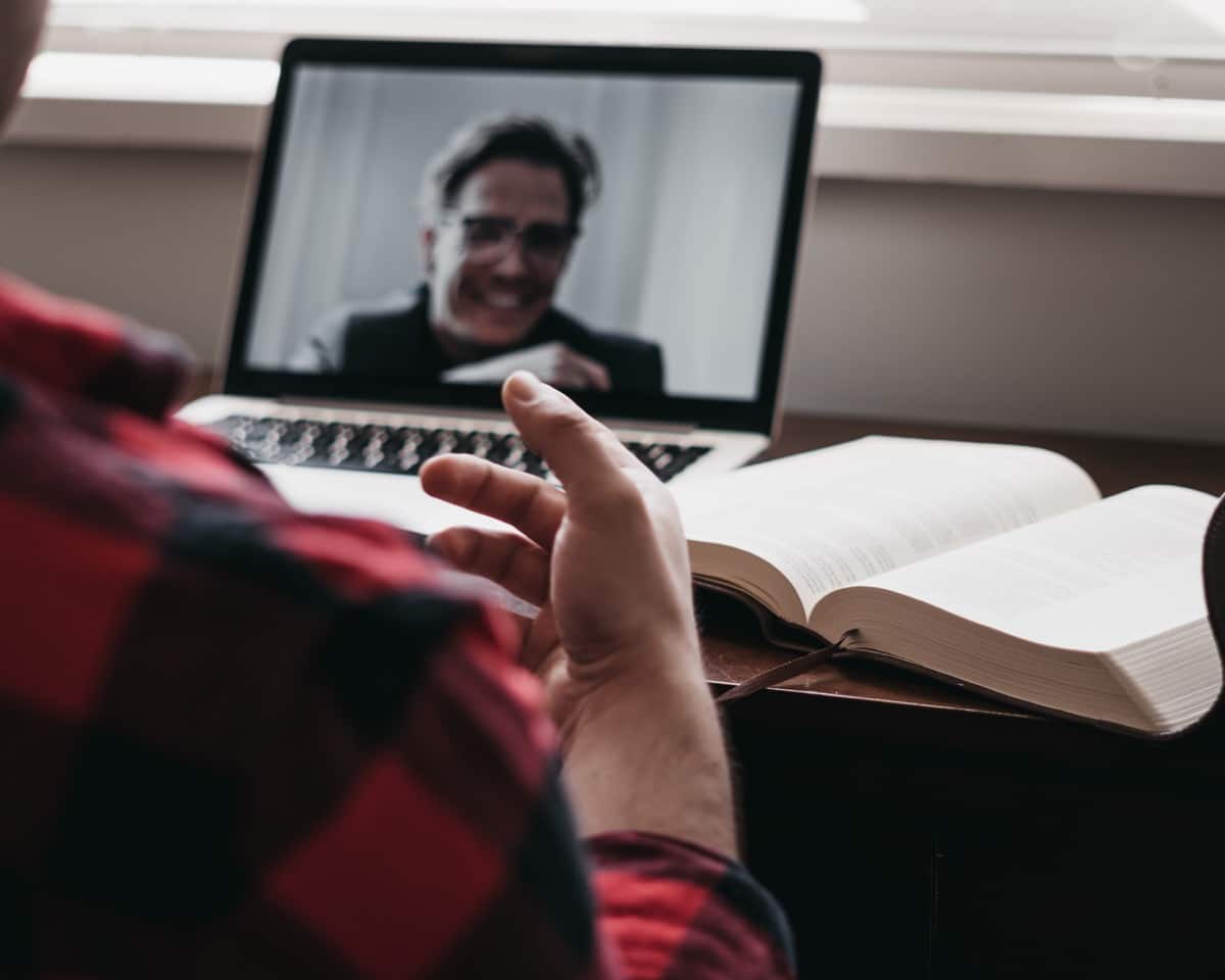laptop and an online interview conducted a kitchen table; remote employer brand concept